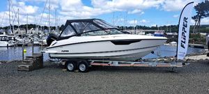 Flipper 700 DC 2023 Flipper 700 DC boat on trailer at marina, clear sky, promotional flag.