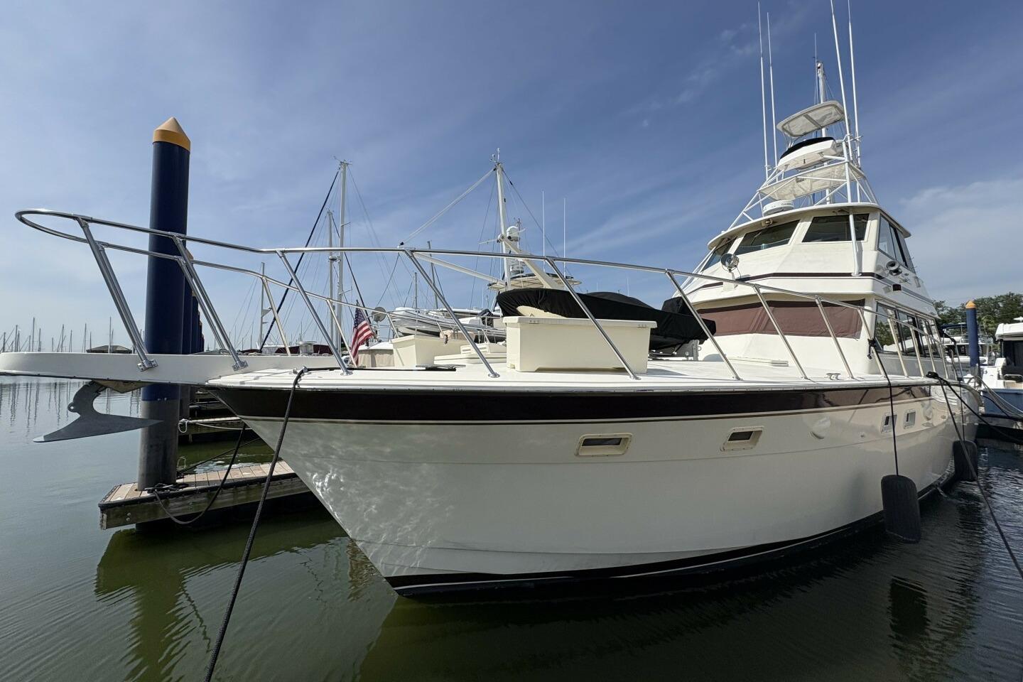 Hatteras 60 enclosed bridge 1985 Hatteras 60 Enclosed Bridge yacht docked at marina under clear sky.