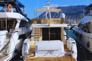 Princess 65 Luxury yacht Princess 65, 2002 model, docked in a marina with mountain backdrop.