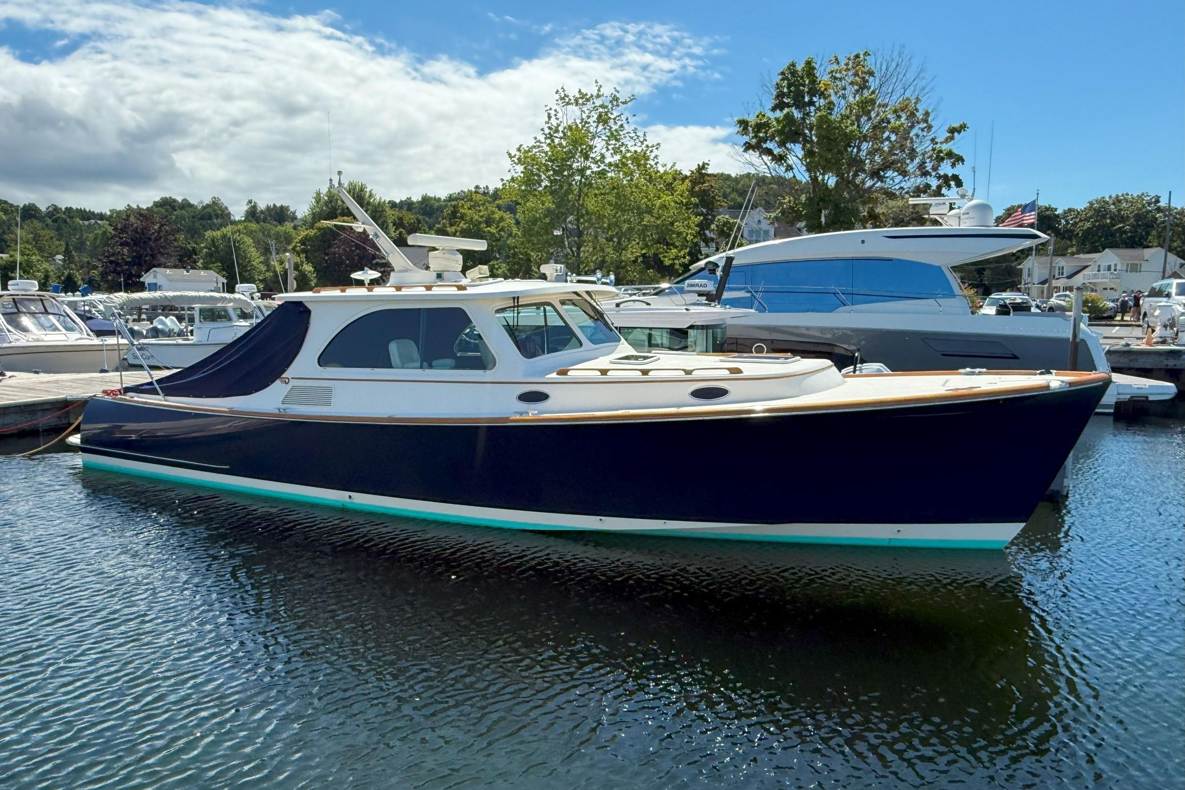 Hinckley Talaria 40 2003 Hinckley Talaria 40 yacht docked in a marina under a clear blue sky.