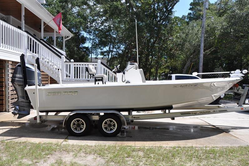 Sea Pro 228 Bay 2021 Sea Pro 228 Bay boat on trailer, parked in driveway near house.
