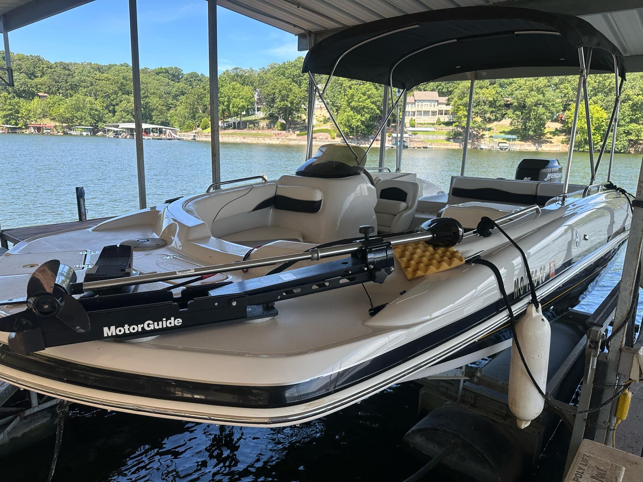 Tahoe 195 OB 2005 Tahoe 195 OB boat docked with MotorGuide trolling motor, scenic lake view.
