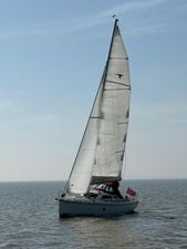 Etap 26i 2004 Etap 26i sailboat on open water under clear skies.