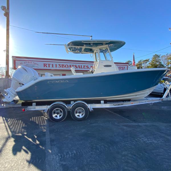 Cobia 240 Center Console 2025 Cobia 240 Center Console boat on trailer at dealership.