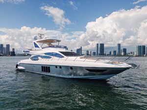 Azimut 64 Flybridge 2016 Azimut 64 Flybridge yacht on water with city skyline background.