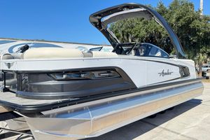 Avalon Excalibur Quad Lounge Windshield 2023 Avalon Excalibur Quad Lounge Windshield pontoon boat, sleek design, outdoor setting.