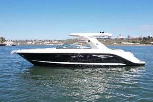 Sea Ray SLX 310 2019 Sea Ray SLX 310 boat on calm water under clear blue sky.