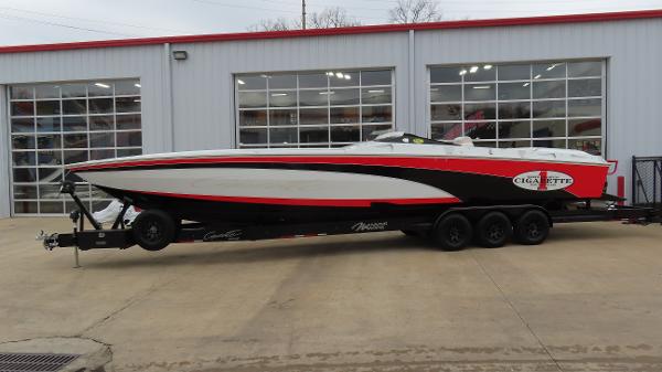 Cigarette 38 Top Gun 2003 Cigarette 38 Top Gun boat on trailer outside garage.