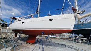 Elan Impression 434 2007 Elan Impression 434 sailboat on stands, white hull, red bottom, clear sky background.