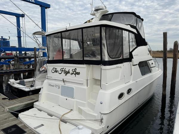 Silverton 392 Motor Yacht 2001 Silverton 392 Motor Yacht docked at marina, featuring enclosed upper deck.
