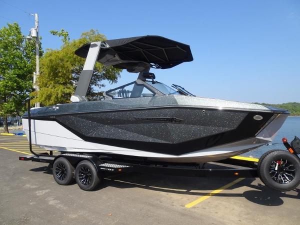 Nautique Super Air Nautique G23 2025 Nautique Super Air Nautique G23 boat on trailer, parked near a lake.