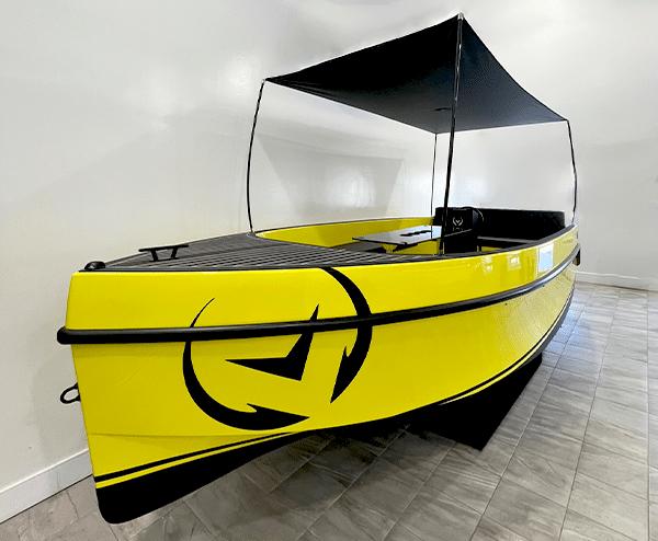 Vision Marine Technologies Volt 180 2023 Vision Marine Technologies Volt 180, bright yellow electric boat with canopy, indoor display.