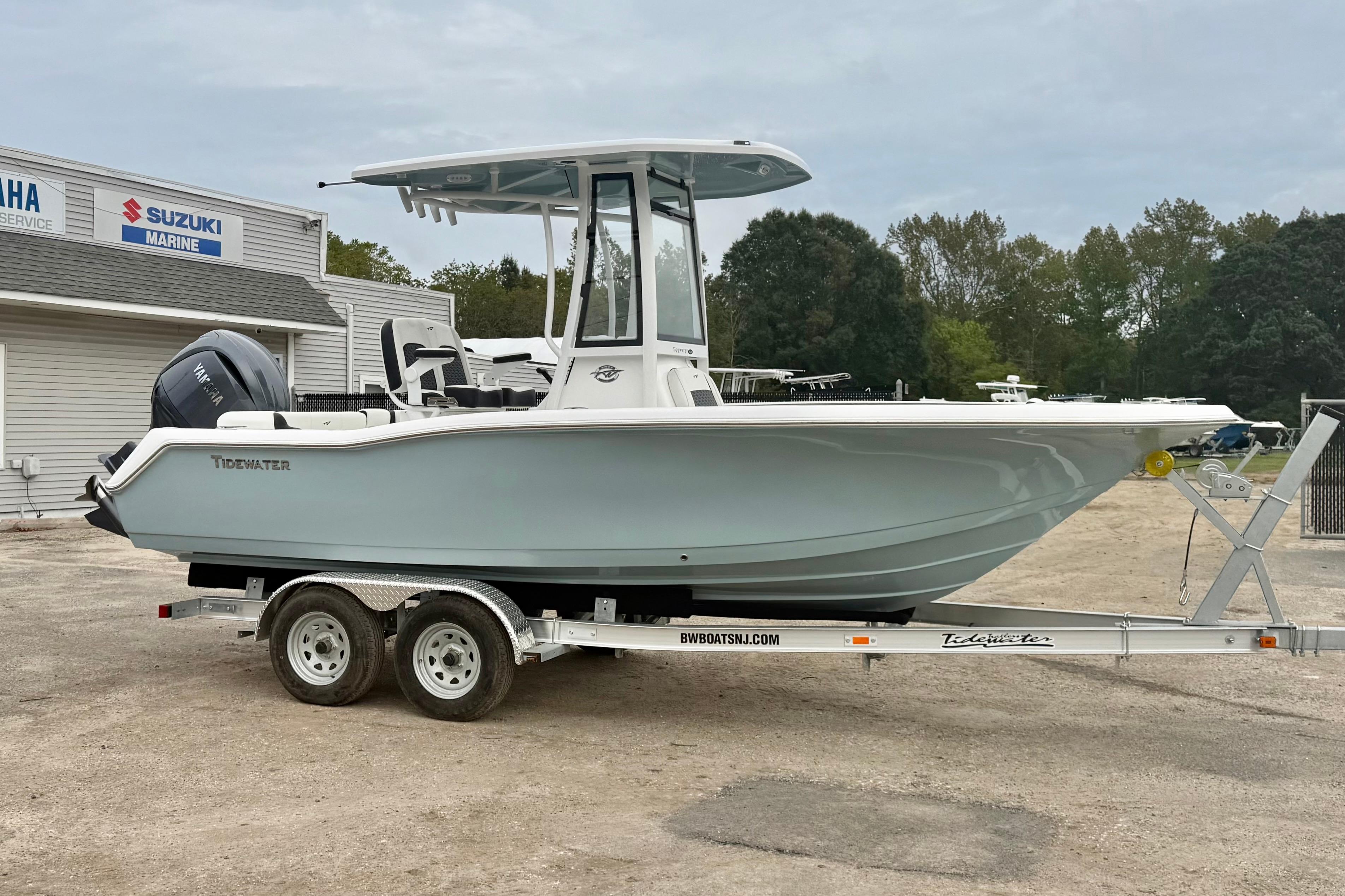Tidewater 210 LXF 2026 Tidewater 210 LXF boat on trailer, parked near marine service center.