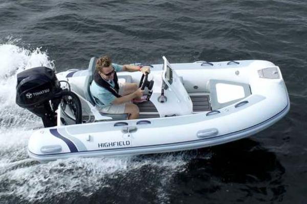 Highfield Classic 340 GT 2024 Highfield Classic 340 GT boat cruising on water with Tohatsu outboard motor.