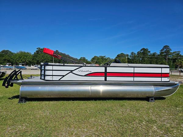 Bentley Pontoons Legacy 243 Cruise 3/4 Tube Tritoon 2025 Bentley Pontoons Legacy 243 Cruise Tritoon on grass under clear blue sky.