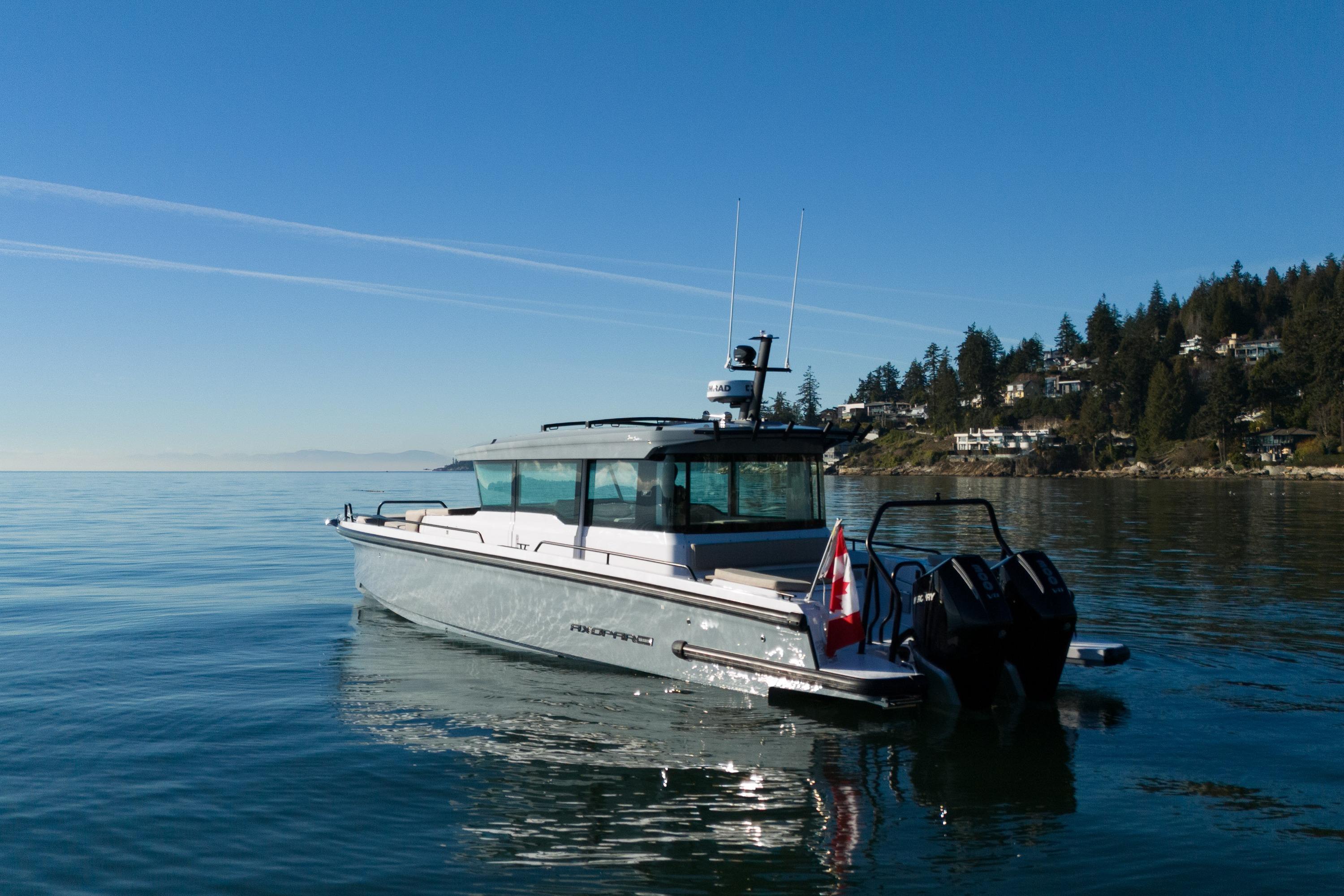 Axopar 37XC Aft Cabin 2026 Axopar 37XC Aft Cabin boat on calm water, scenic coastal backdrop.