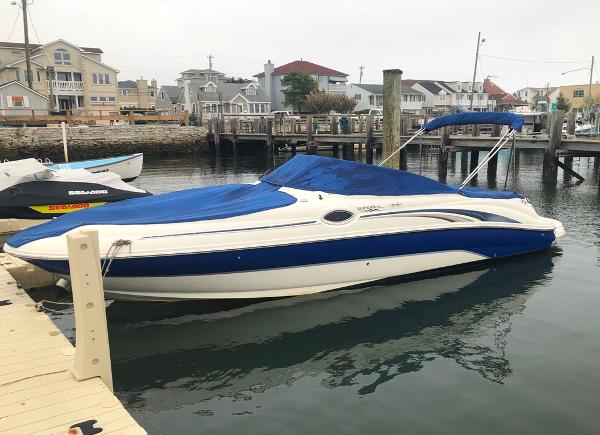 Sea Ray 240 Sundeck 2004 Sea Ray 240 Sundeck boat docked with blue cover in marina.