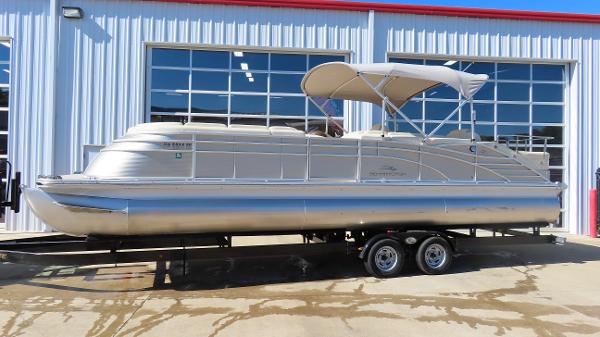 Bennington 2875 QCW I/O 2013 Bennington 2875 QCW I/O pontoon boat on trailer, parked outside a garage.
