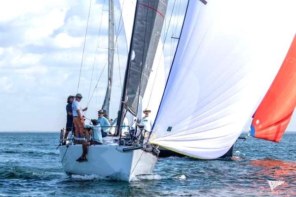 J Boats J/111 Sailing J Boats J 111, 2015 model, on open water with crew and colorful sails.