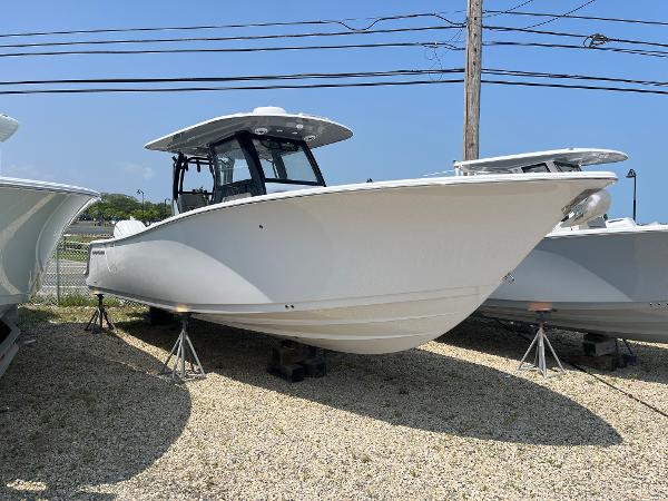 Sportsman Open 302 Center Console 2025 Sportsman Open 302 Center Console boat displayed on stands outdoors.