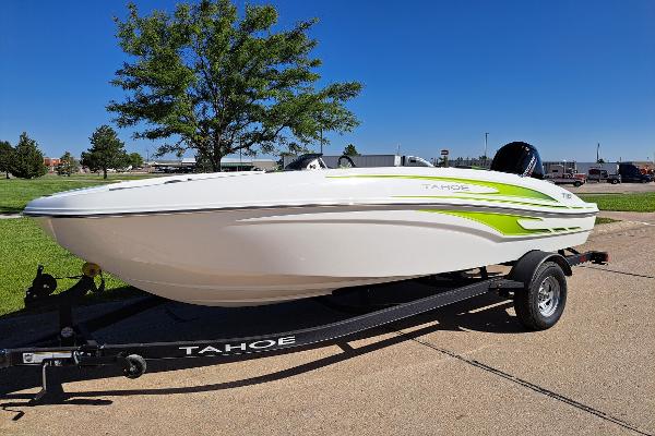 Tahoe T18 2024 Tahoe T18 boat on trailer, white with green accents, parked outdoors.