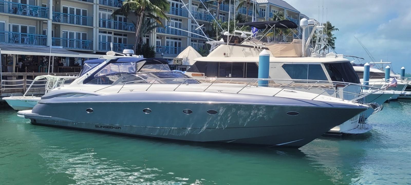 Sunseeker Predator 56 2003 Sunseeker Predator 56 yacht docked in marina, surrounded by other boats.