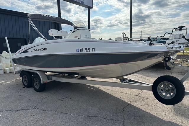 Tahoe 2150 CC 2022 Tahoe 2150 CC boat on trailer, parked outdoors under cloudy sky.