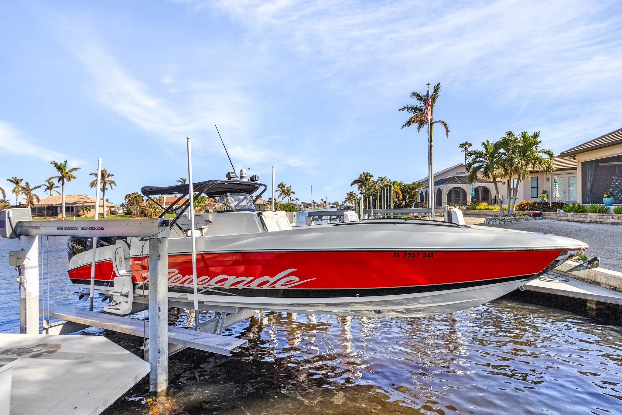 Renegade 33' Open 2020 Renegade 33' Open boat docked, featuring sleek red and white design.