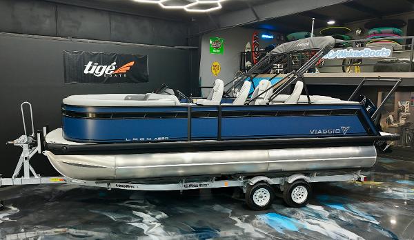 Viaggio Lago X-Q 2025 Viaggio Lago X-Q pontoon boat on trailer in showroom setting.