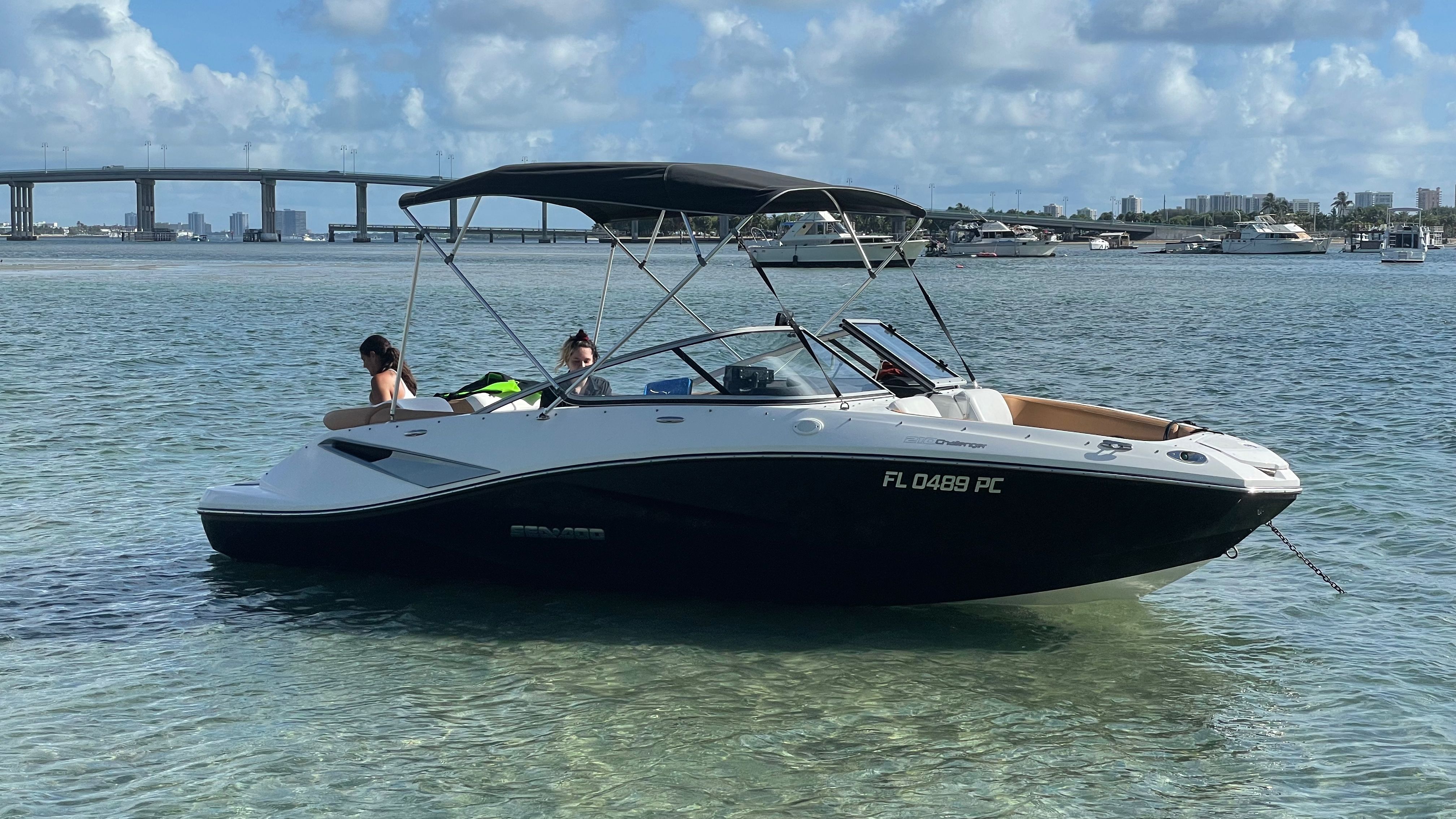 Sea-Doo Sport Boats 210 Challenger SE 2010 Sea-Doo 210 Challenger SE boat anchored in clear water, with bridge and cityscape background.