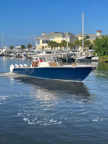 Valhalla Boatworks V-41 2021 Valhalla Boatworks V-41 cruising in a marina with waterfront buildings.