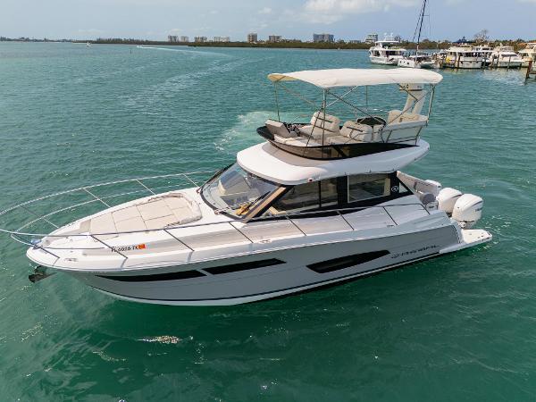 Regal 38 FXO 2023 Regal 38 FXO yacht cruising on clear blue water.