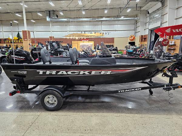 Tracker Pro Guide V-16 SC 2025 Tracker Pro Guide V-16 SC boat displayed indoors on a trailer.