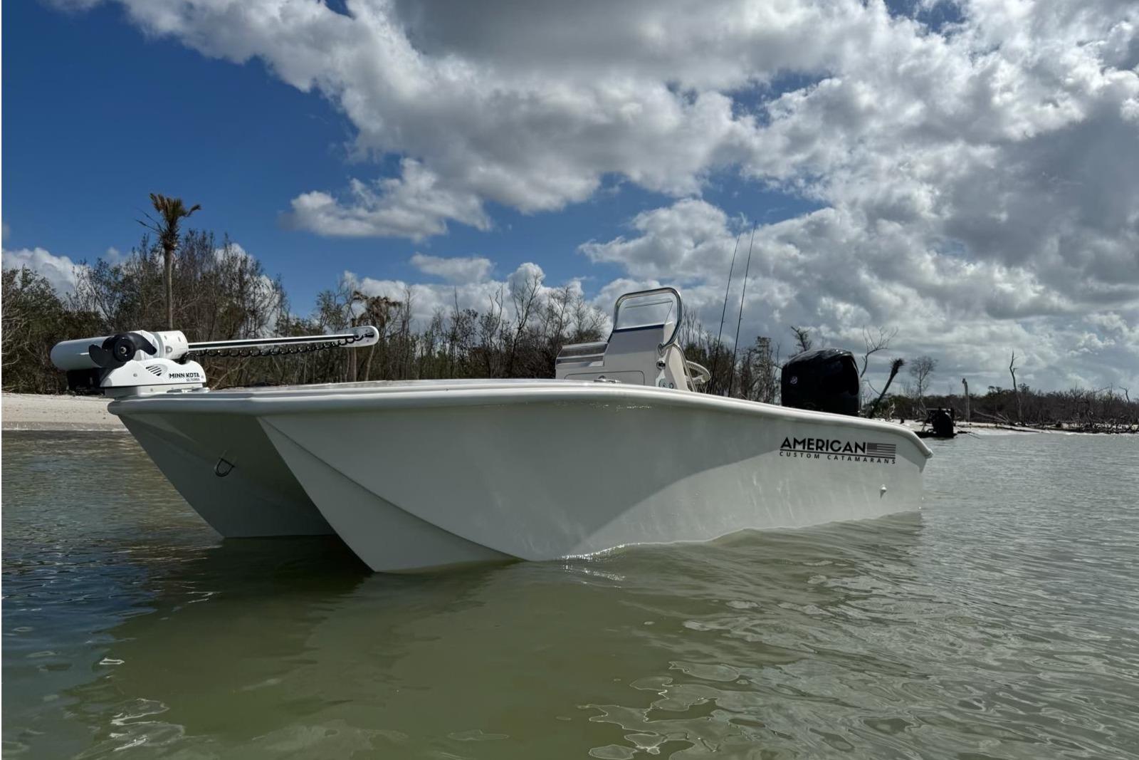 American Custom Catamarans 17 2026 American Custom Catamarans 17LF boat on calm water under cloudy sky.