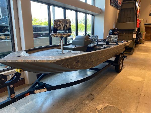 Tracker Grizzly 1754 SC 2024 Tracker Grizzly 1754 SC boat displayed indoors on a trailer.