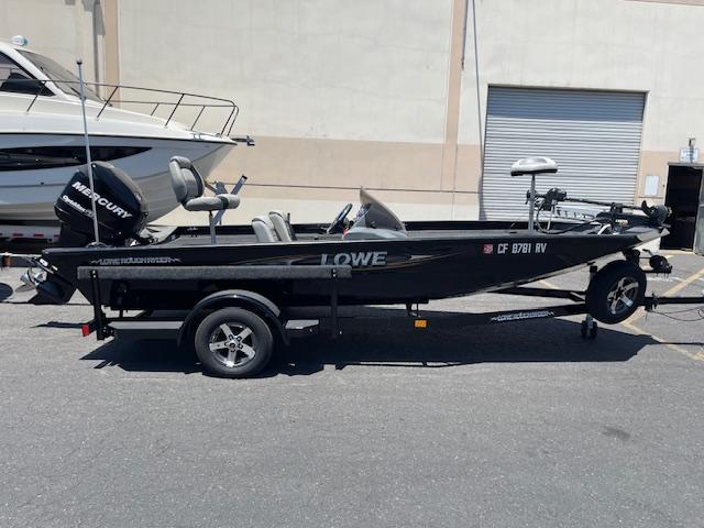 Lowe Stinger 18 HP 2014 Lowe Stinger 18 HP fishing boat on trailer, parked outdoors.