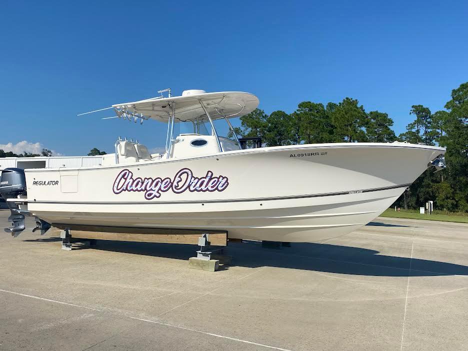 Regulator 31 2018 Regulator 31 boat named "Change Order" on display, clear sky background.