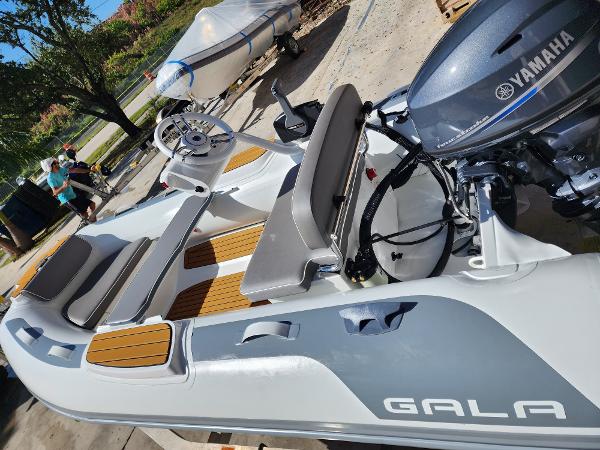 Gala A330hq 2024 Gala A330hq inflatable boat with Yamaha motor, docked outdoors.