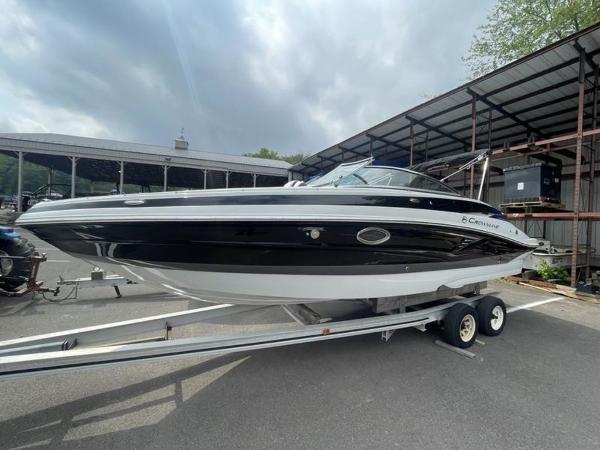 Crownline 260 SS 2024 Crownline SS 260 boat on a trailer in a marina.