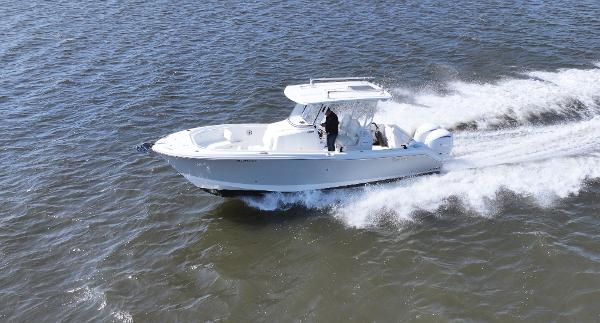 Edgewater 280CC 2022 Edgewater 280CC boat cruising on open water at high speed.
