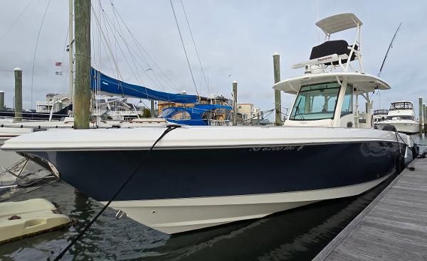 Boston Whaler 350 Outrage 2015 Boston Whaler 350 Outrage docked at marina, side view.