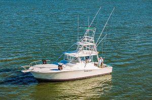 Luhrs 40 Open 2000 Luhrs 40 Open boat on water, featuring fishing equipment and spacious deck.