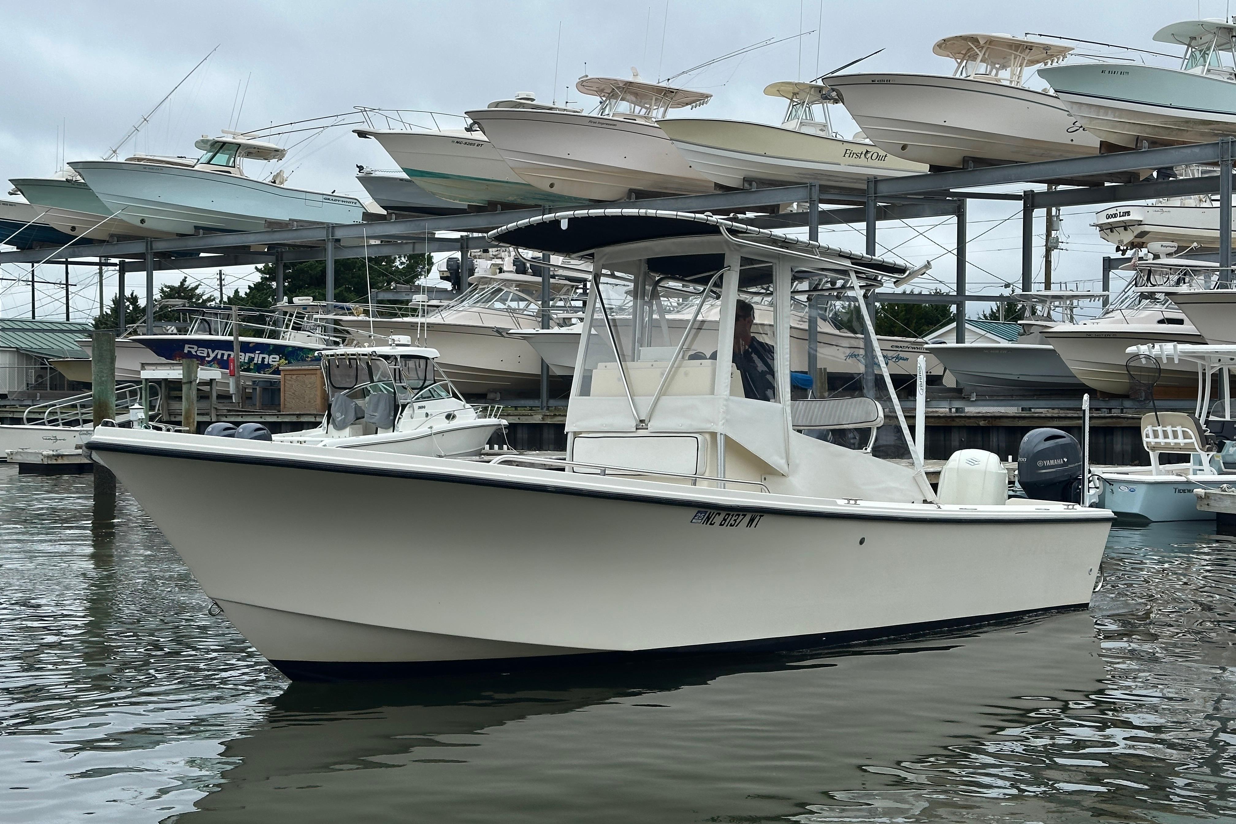Parker 2300 Special Edition 2001 Parker 2300 Special Edition boat docked at marina with stacked vessels.