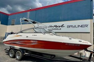 Yamaha Boats AR230 HO 2007 Yamaha AR 230 boat on trailer, parked outside dealership with blue and red building.