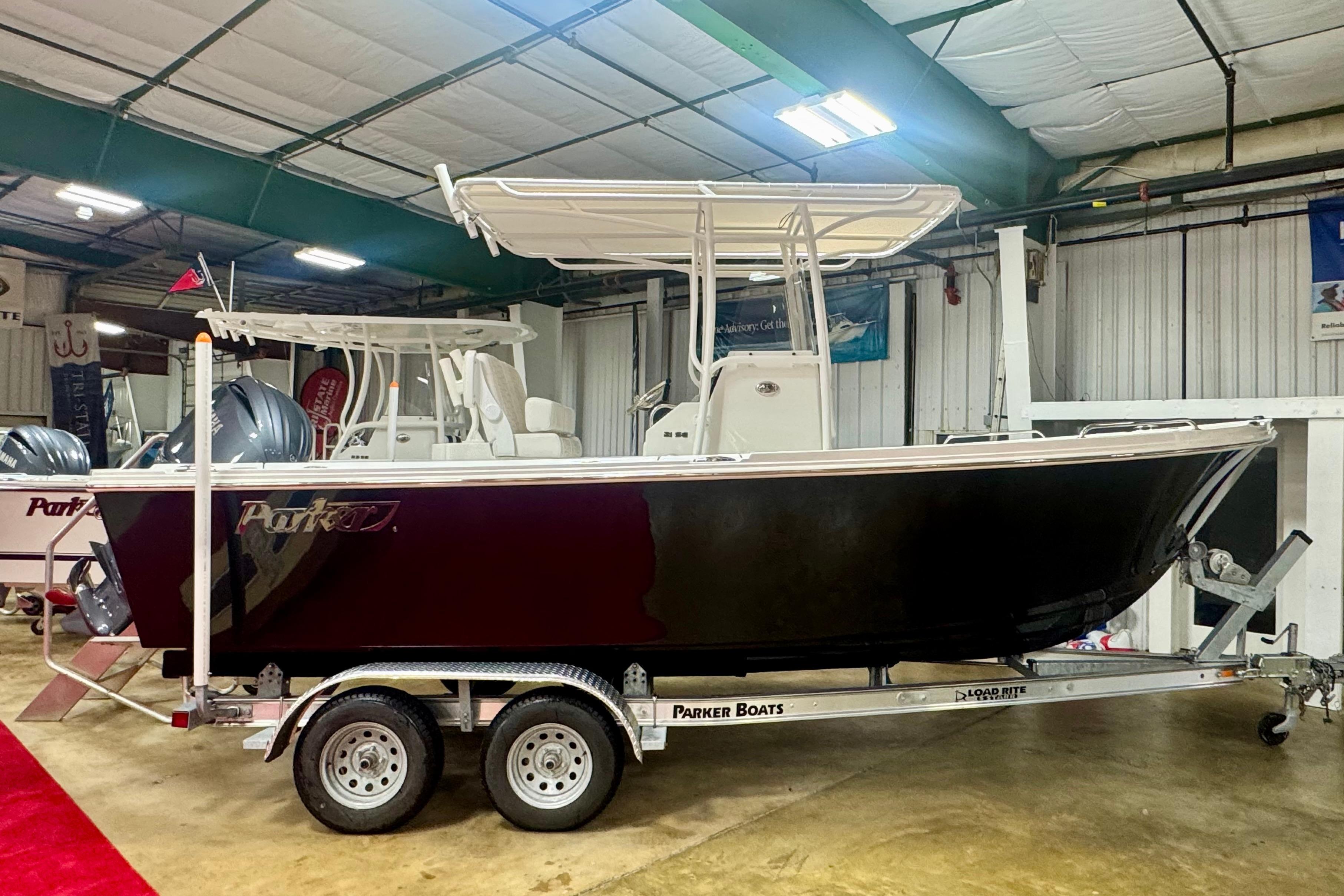 Parker 21SE Center Console 2026 Parker 21SE Center Console boat on trailer in indoor showroom.