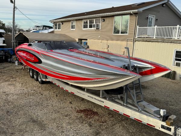 Nor-Tech 4000 Roadster 2010 Nor-Tech 4000 Roadster powerboat on trailer, featuring sleek red and silver design.