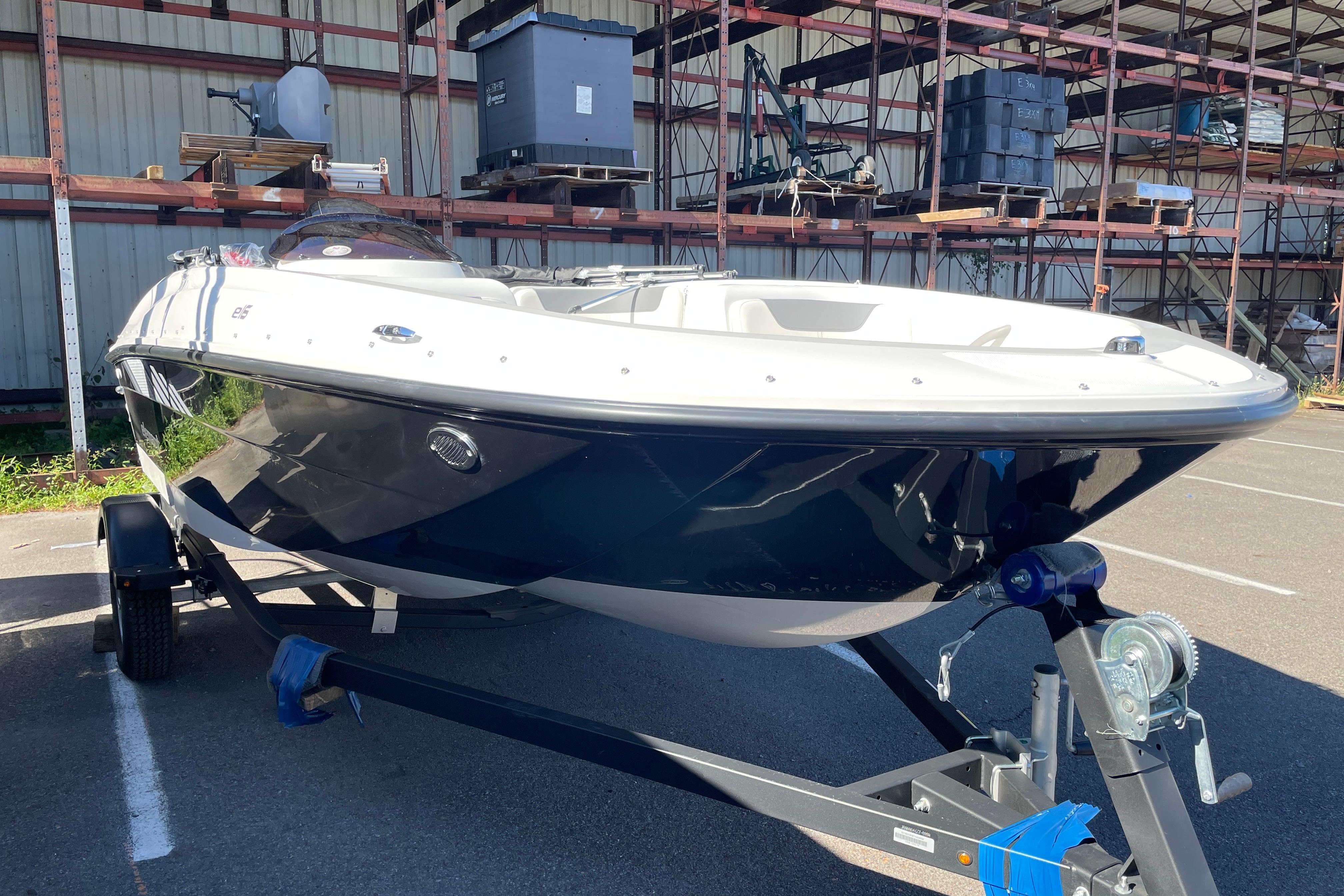 Bayliner Element E16 2026 Bayliner Element E16 boat on trailer in storage facility.