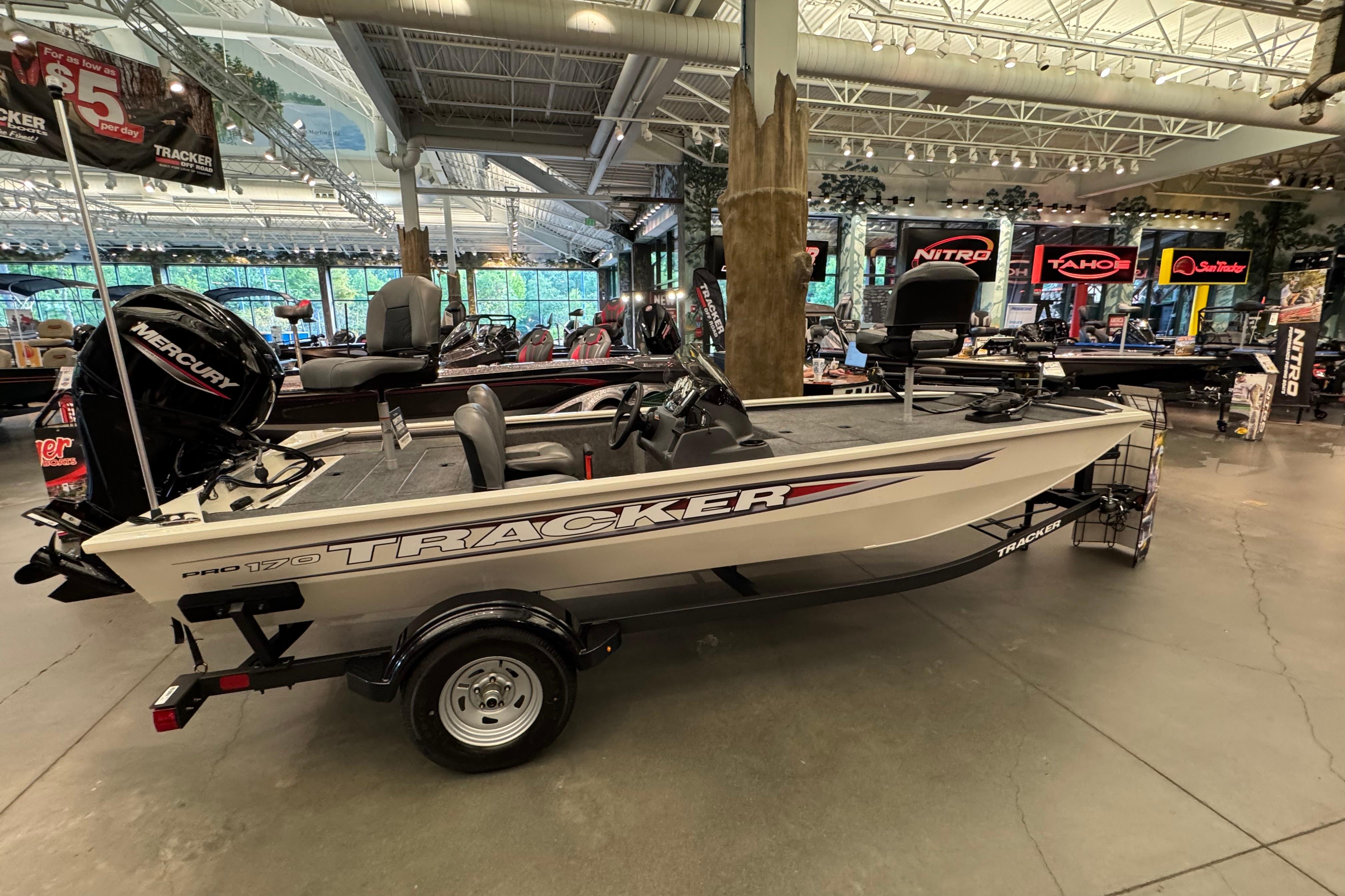 Tracker Pro 170 2026 Tracker Pro 170 boat displayed in showroom with Mercury engine.