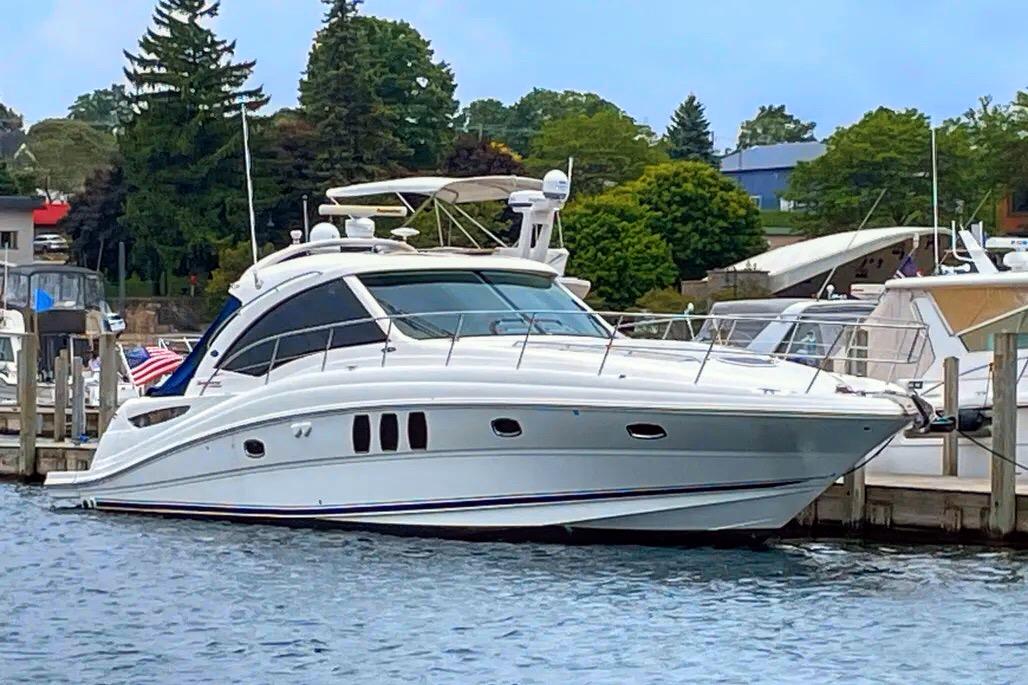Sea Ray 500 Sundancer 2010 Sea Ray 500 Sundancer yacht docked at a marina, surrounded by water and trees.