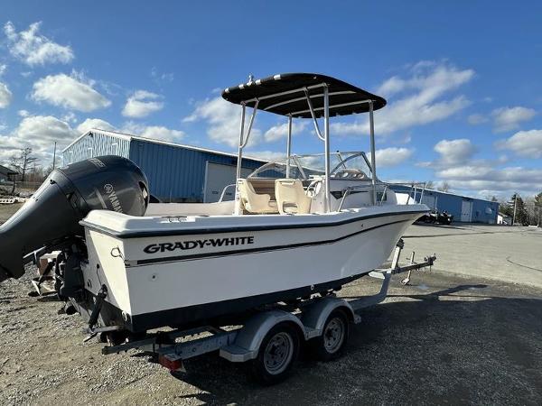 Grady-White 208 Adventure 1997 Grady-White 208 Adventure boat on trailer, parked outdoors under blue sky.